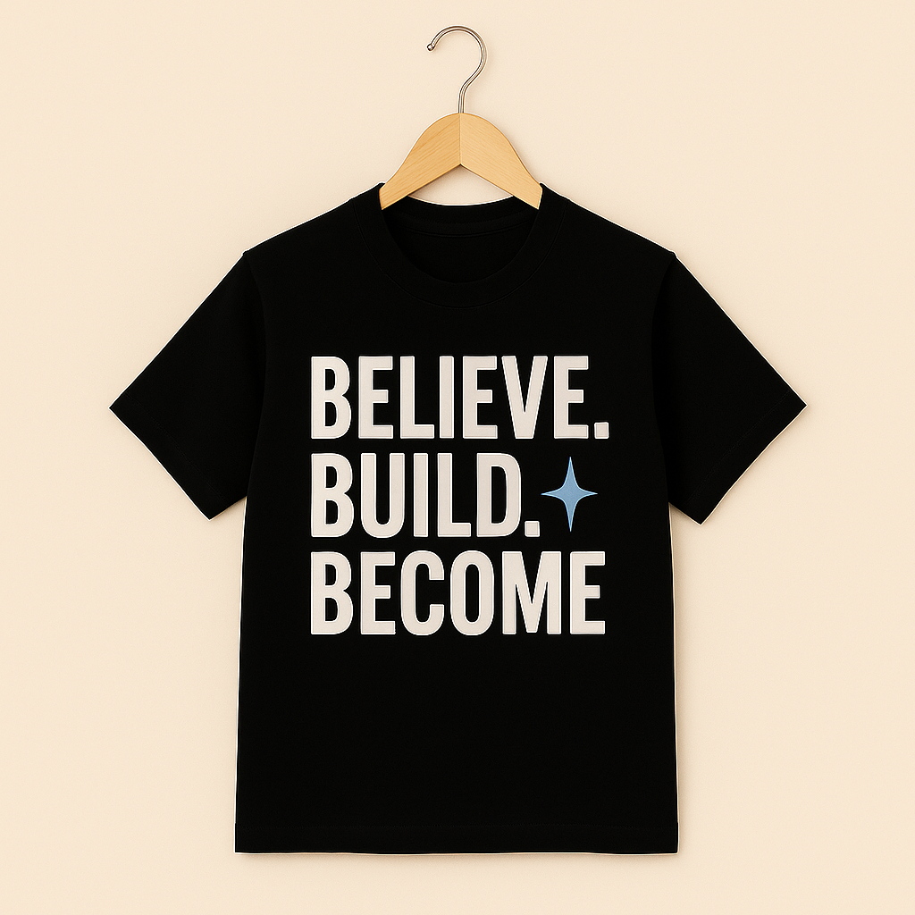 Black t-shirt with 'BELIEVE. BUILD. BECOME' text on a hanger with beige background