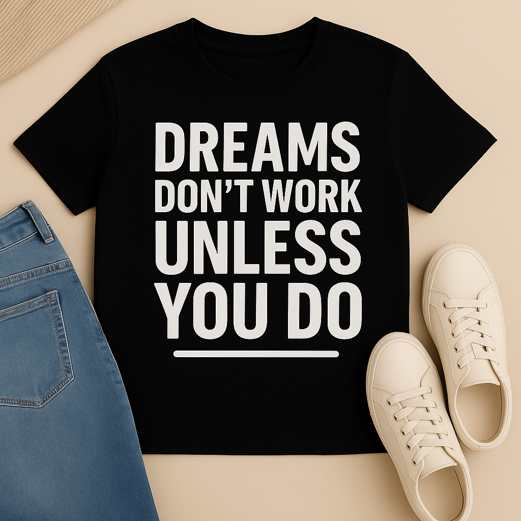 Black t-shirt with motivational quote, blue jeans, and white sneakers on a beige surface