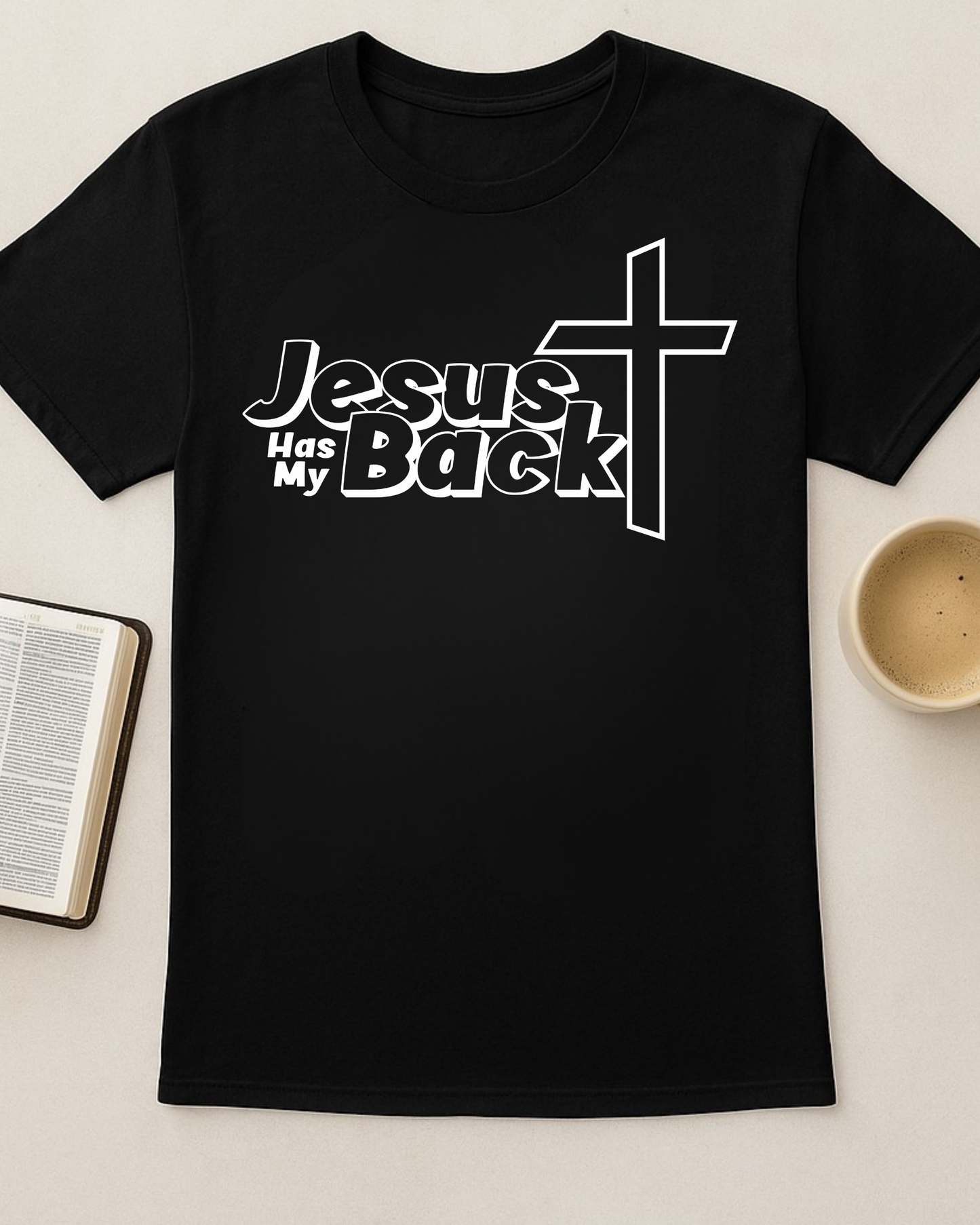 Black “Jesus Has My Back” Christian T-shirt flat lay with Bible and coffee cup