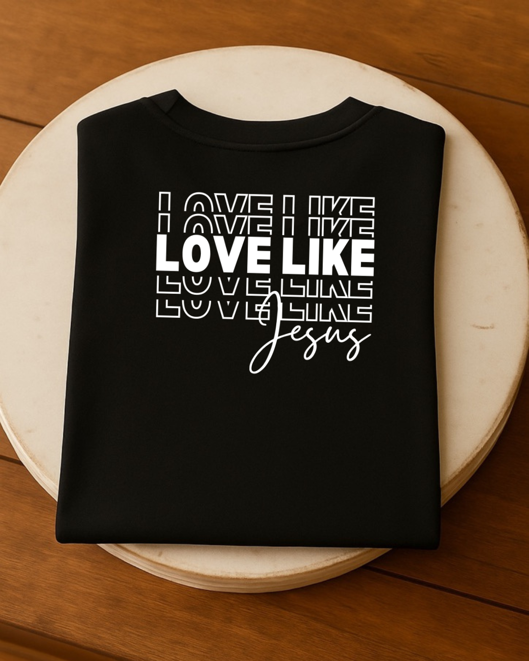 Black Love Like Jesus Christian T-shirt flat lay showing bold faith typography design
