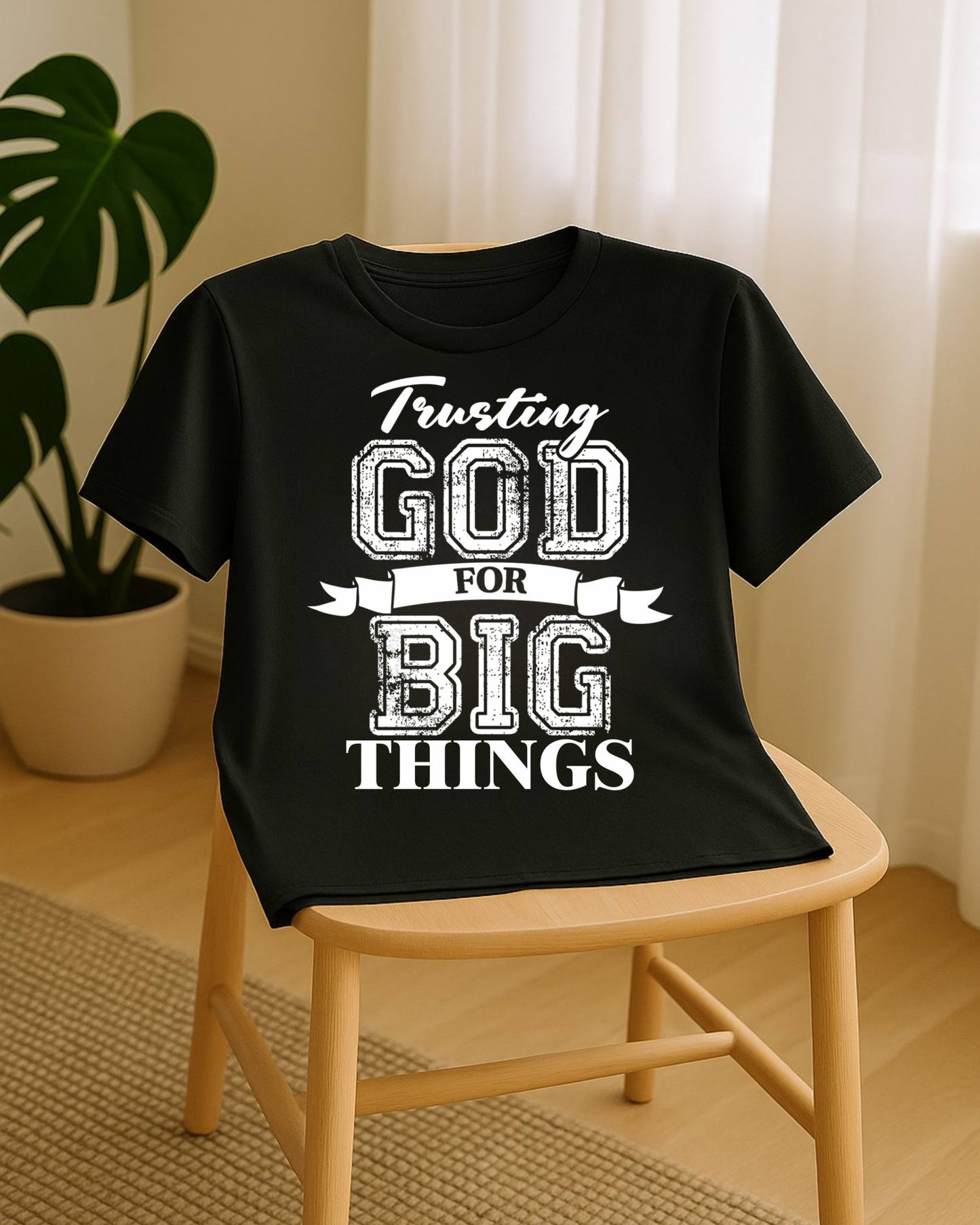 Black Christian t-shirt on chair featuring trusting God for big things faith message