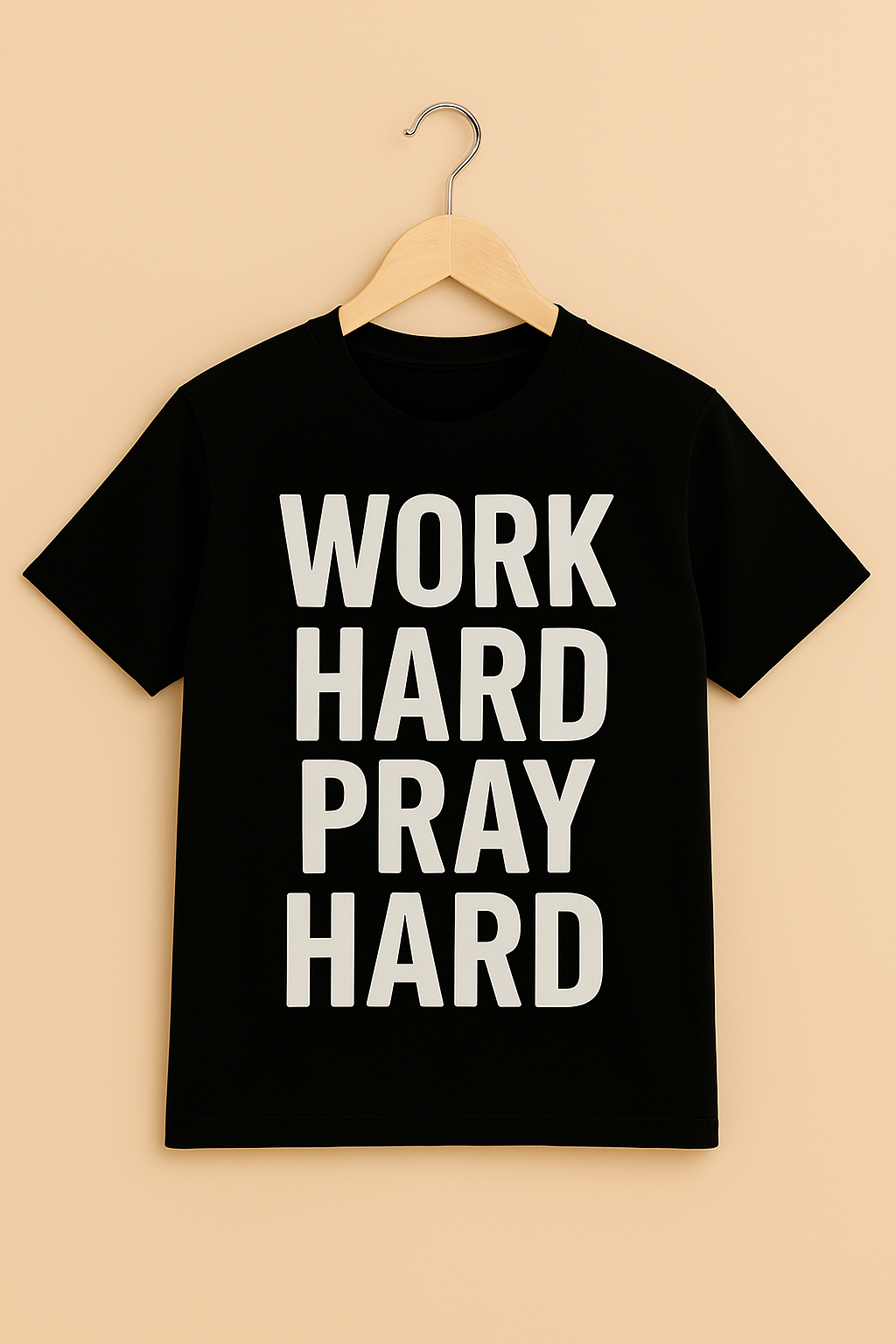 Black t-shirt with 'WORK HARD PRAY HARD' text with hanger on a beige background